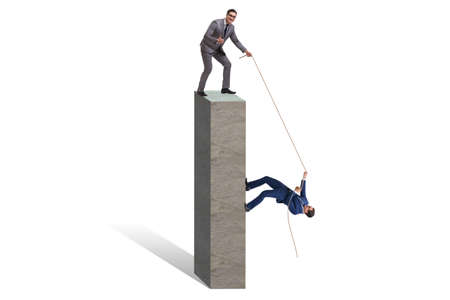 Businessman helping colleague with rope