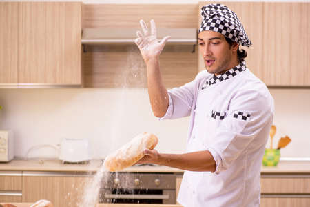 Young male baker working in kitchen
