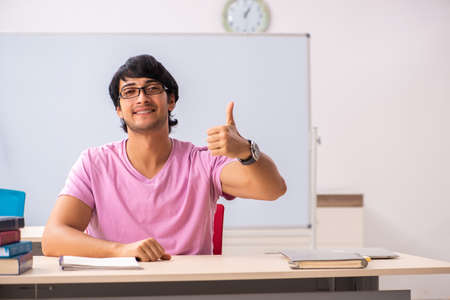 Young male student sitting in the classの写真素材