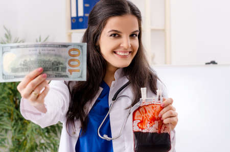 Female doctor in blood transfusion conceptの写真素材