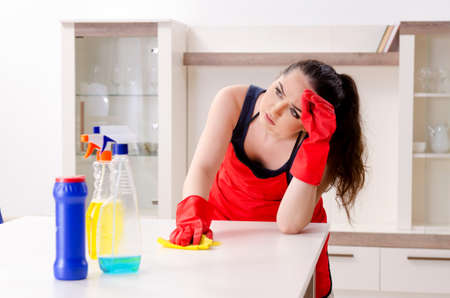 Young beautiful woman cleaning apartmentの写真素材