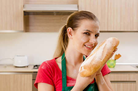 Young female baker working in kitchen