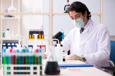 Young handsome chemist working in the labの写真素材