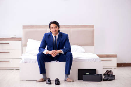 Young handsome businessman choosing shoes at homeの写真素材