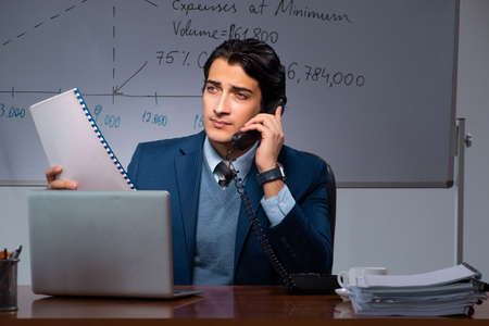 Financial specialist working late in the office