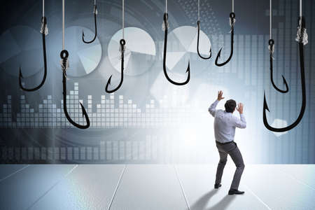 Businessman being tempted to bite the baitの写真素材