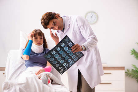 Young doctor examining injured patientの写真素材
