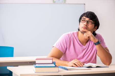 Young male student sitting in the classの写真素材