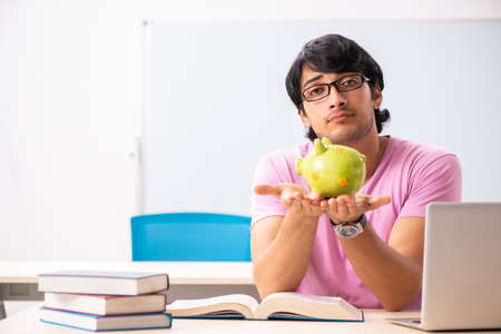 Young male student sitting in the classの写真素材