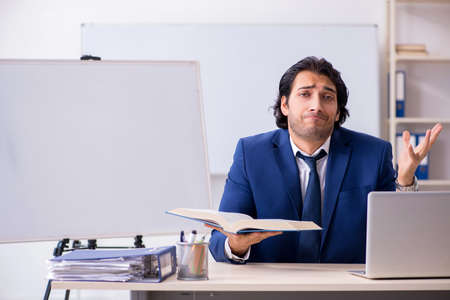 Young handsome businessman working in the office