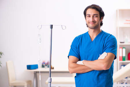 Young male doctor in blood transfusion conceptの写真素材