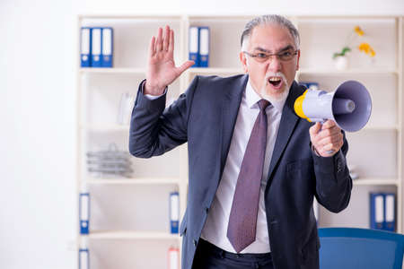 White bearded old businessman employee unhappy with excessive workの写真素材