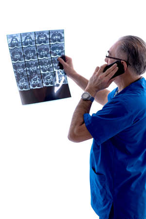 White bearded old doctor radiologist working in clinic