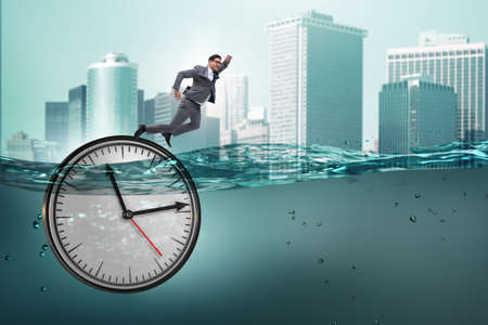 Businessman in deadline and time management conceptの写真素材