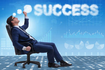Young businessman dreaming of better thingsの写真素材