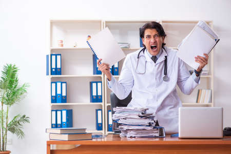 Young handsome doctor working in the clinicの写真素材