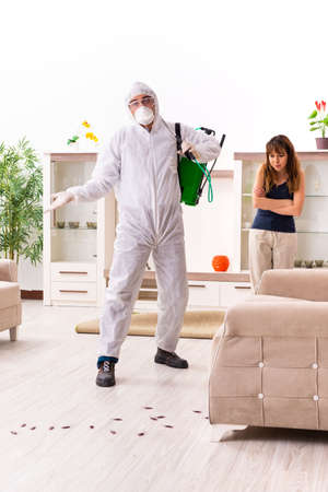 Young professional contractor doing pest control at flatの写真素材