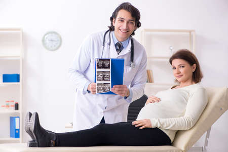 Old pregnant woman visiting young male doctor