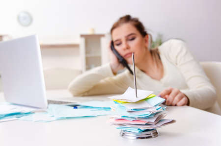 Young pregnant woman in budget planning conceptの写真素材