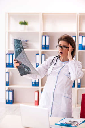 Aged female doctor radiologist in the clinicの写真素材