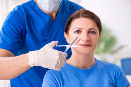 Woman visiting male doctor for plastic surgery