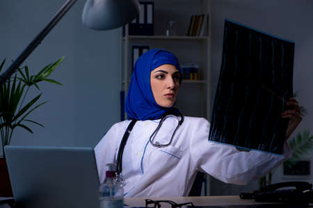 Arab female doctor working in the clinic at nightの写真素材