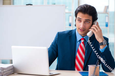 Young handsome businessman in front of whiteboardの写真素材
