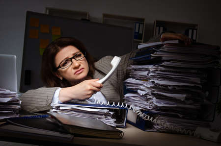 Female employee suffering from excessive workの写真素材