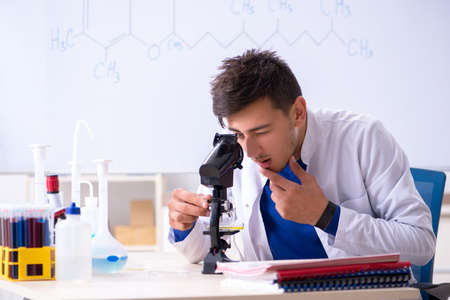 Young chemist sitting in the labの写真素材