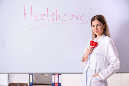 Young female doctor standing in front of the white boardの写真素材