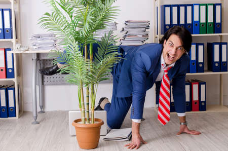 Young businessman employee unhappy with excessive workの写真素材