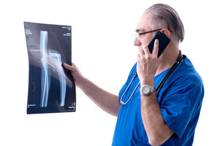 White bearded old doctor radiologist working in clinic