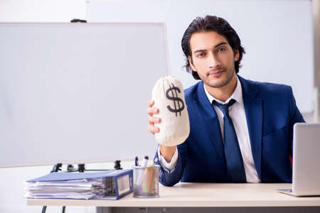 Young handsome businessman working in the officeの写真素材