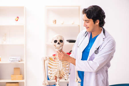 Young male doctor with skeleton