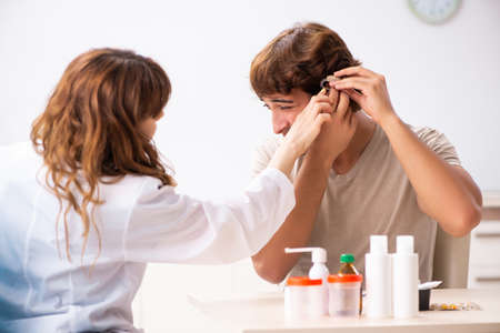 Patient with hearing problem visiting doctor otorhinolaryngologiの写真素材