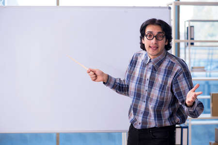 Funny male teacher in front of whiteboardの写真素材