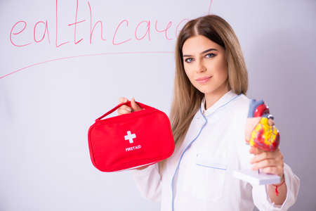 Young female doctor standing in front of the white boardの写真素材