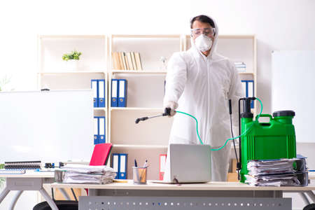 Professional contractor doing pest control at officeの写真素材