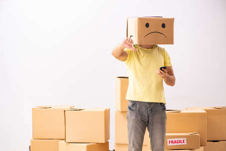 Unhappy man with box instead of his head