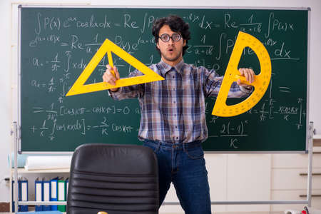 Funny male math teacher in the classroom