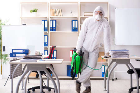 Professional contractor doing pest control at officeの写真素材