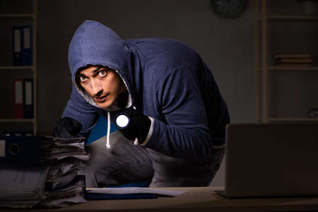 Thief trying to steal personal data in identity theft conceptの写真素材