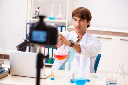 Chemist blogger recording video for his blogの写真素材