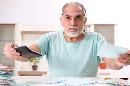 White bearded old man in budget planning concept