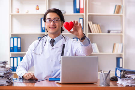 Young handsome doctor working in the clinicの写真素材