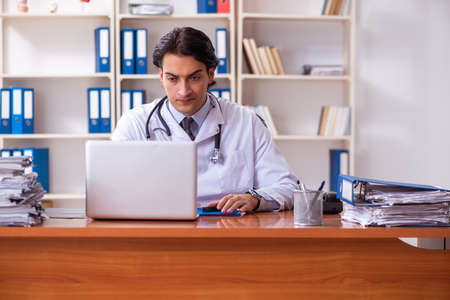 Young handsome doctor working in the clinicの写真素材