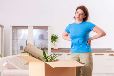 Middle-aged woman moving to new flat