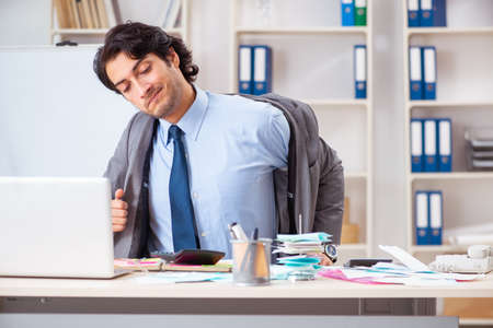 Young handsome businessman in budget planning conceptの写真素材