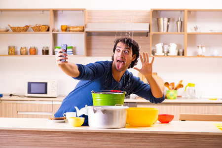 Young man in water leakage from the neighbors conceptの写真素材