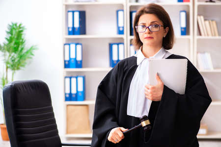 Middle-aged female doctor working in courthouseの写真素材